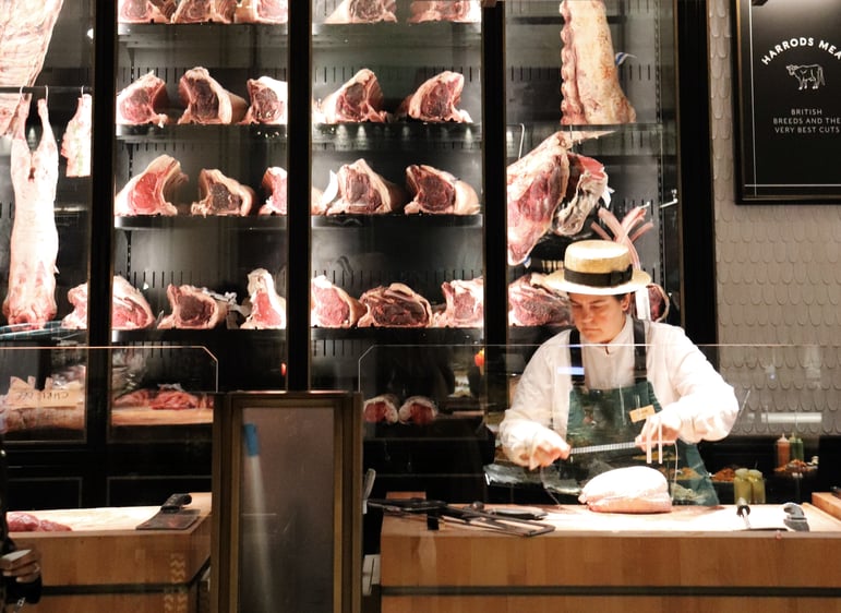Indepedent butcher packaging meat for a customer